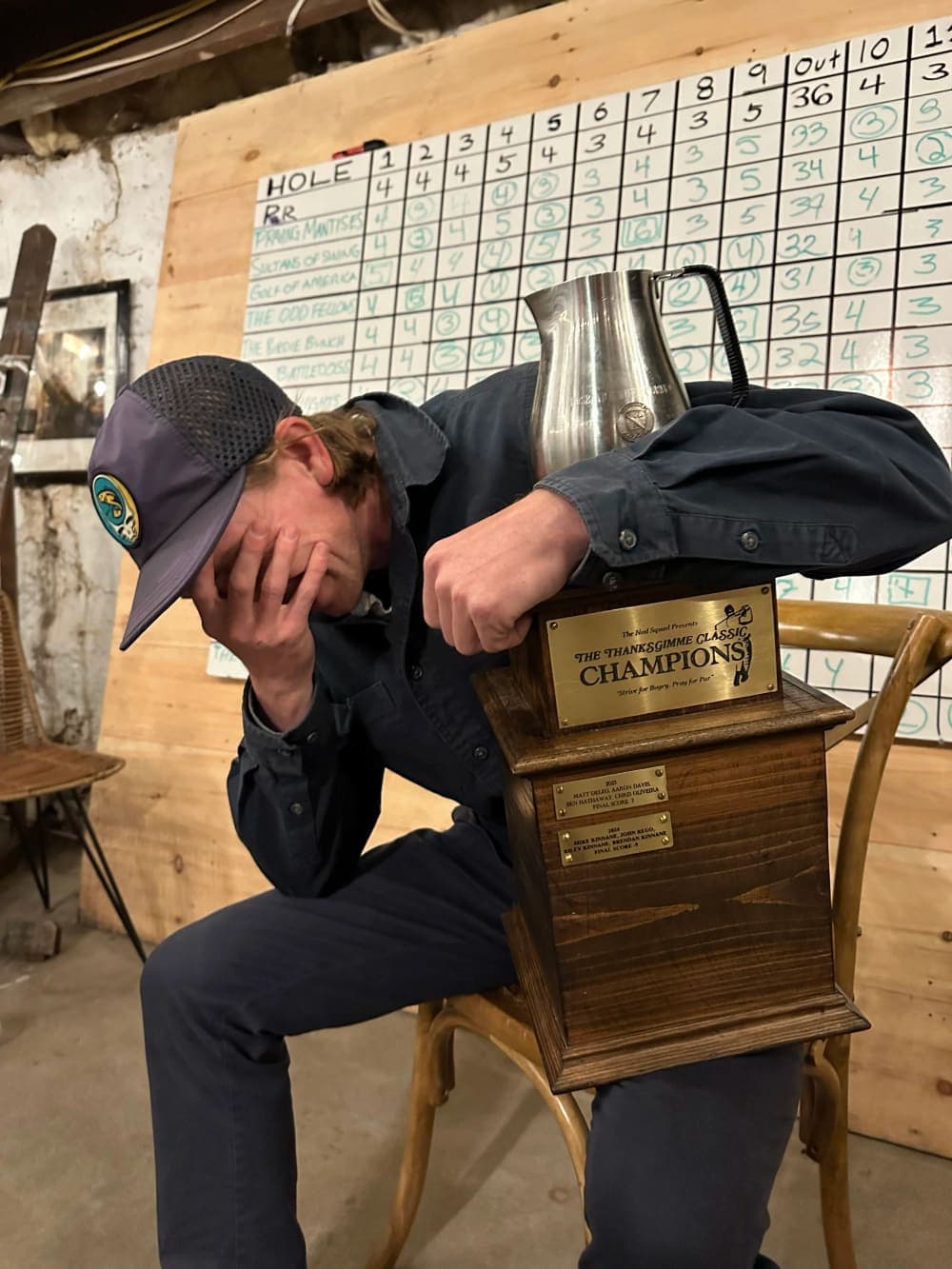 A player slumped over the trophy, head in hand